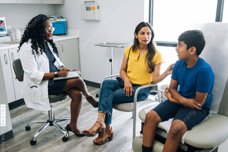 Indian mother and son consulting doctor