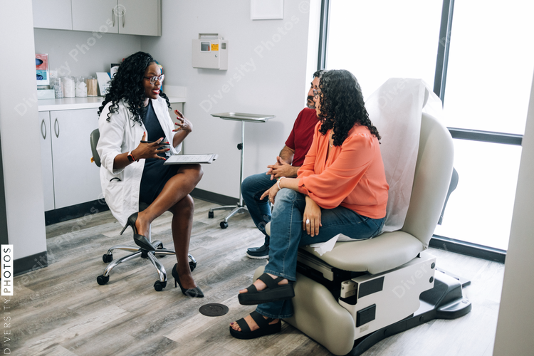 Black family medicine doctor consulting Hispanic patients