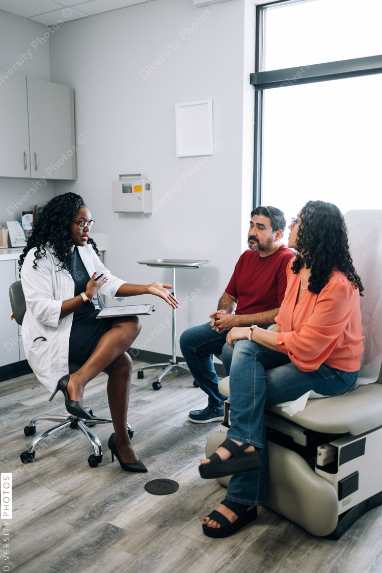 Black family medicine doctor consulting Hispanic patients