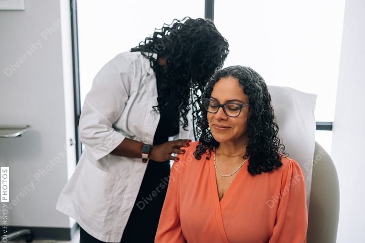 Black doctor consulting with female patient
