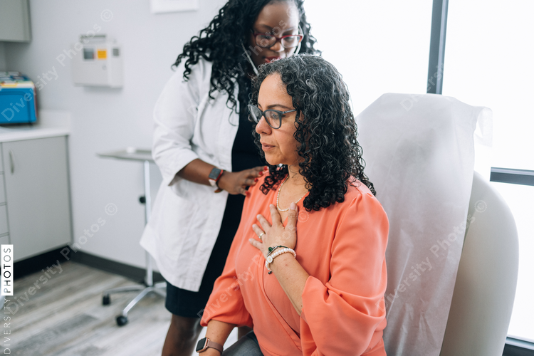 Black doctor consulting with female patient
