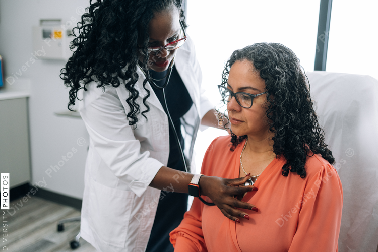 Black doctor consulting with female patient