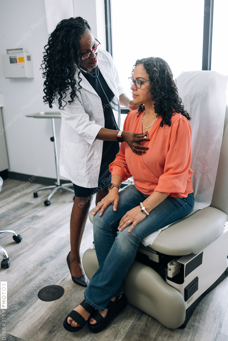 Black doctor consulting with female patient