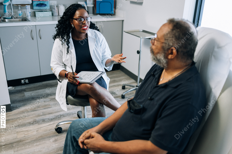 Black doctor consulting male patient