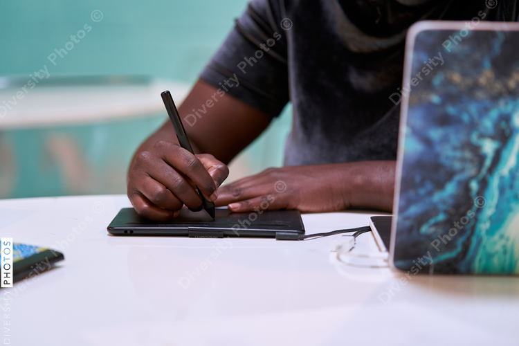 Black graphic design artist creative working on school project, on laptop