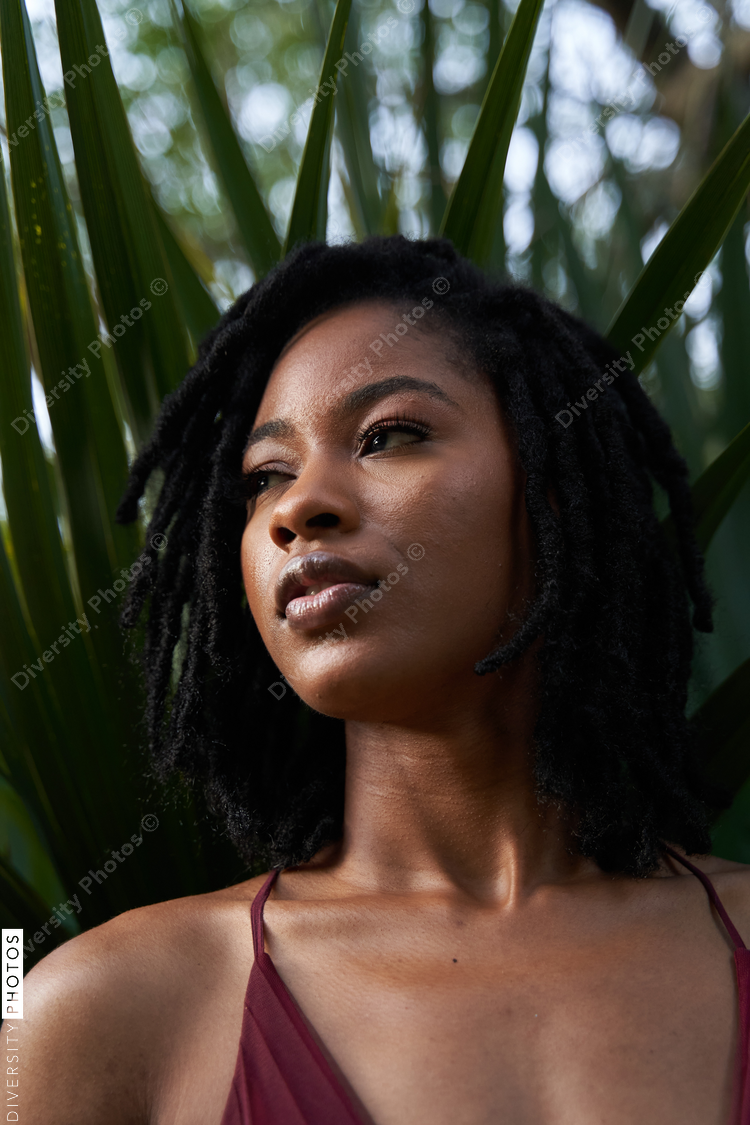 Portrait of confident African American woman with plants