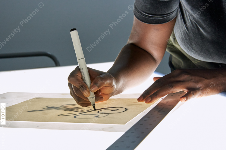 Black female artist creative drawing in studio