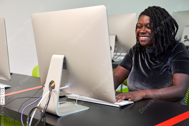 Black woman college student studying in computer lab