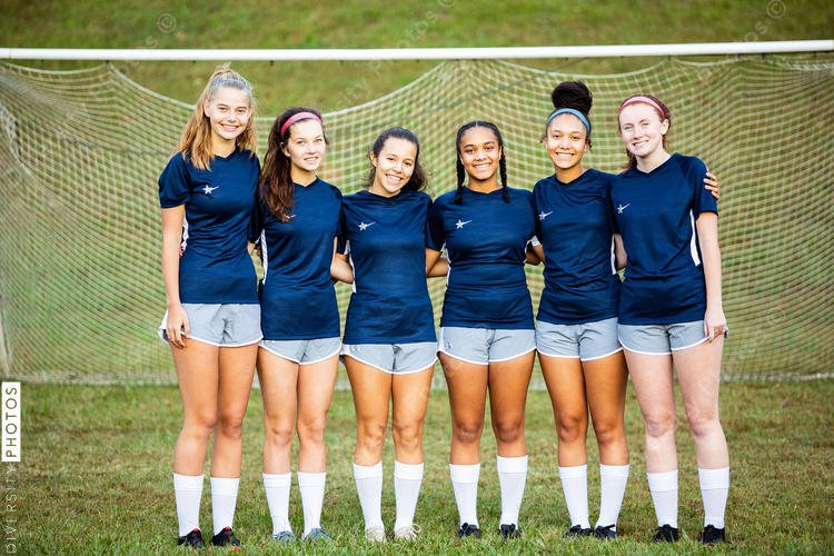 Teammate togetherness portraits on soccer field