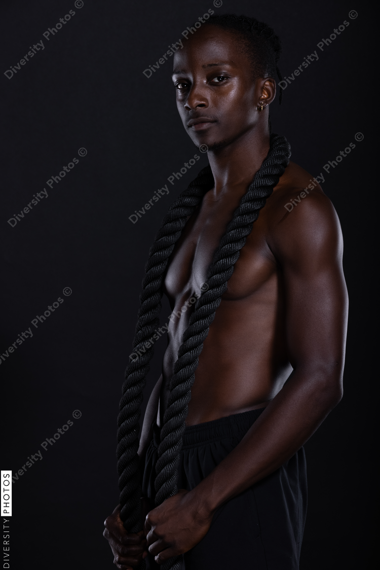 Fit African American man with muscles posing in studio