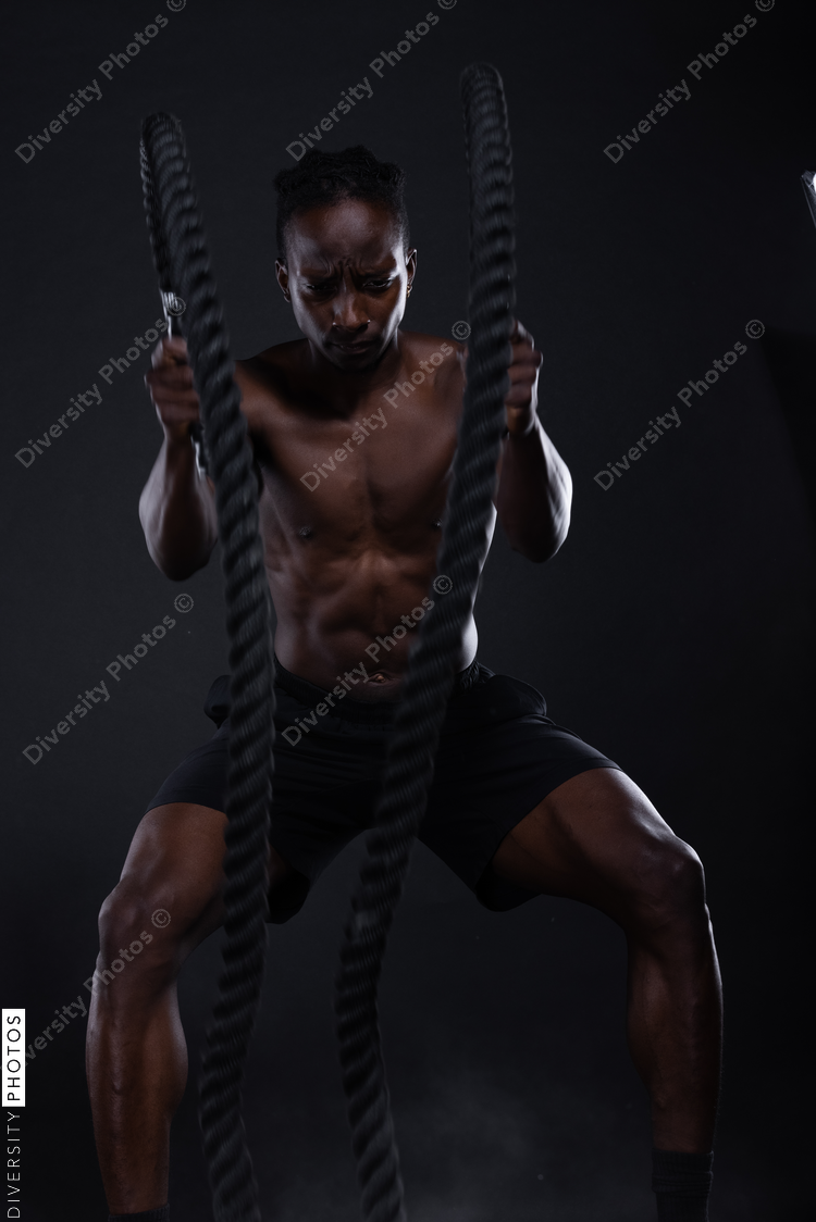 African American man doing intense sports training, exercises 