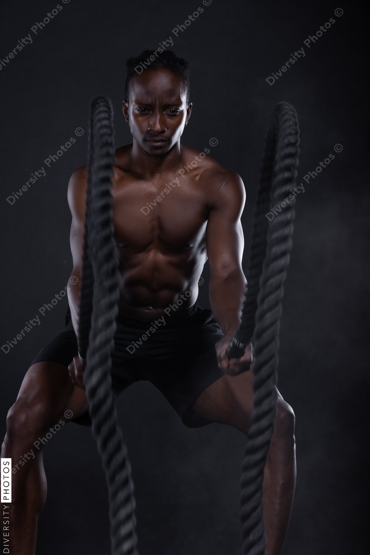 African American man doing intense sports training, exercises