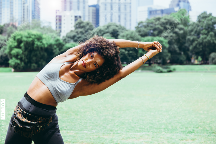 Young woman exercising in city park