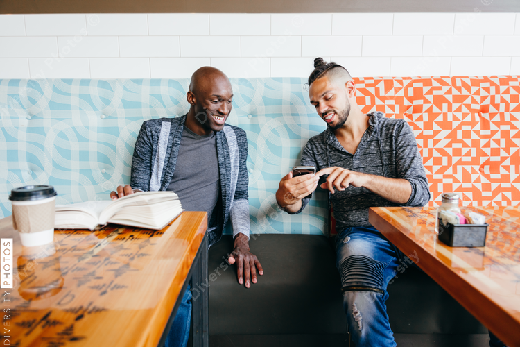 Two people browsing mobile phone and smiling
