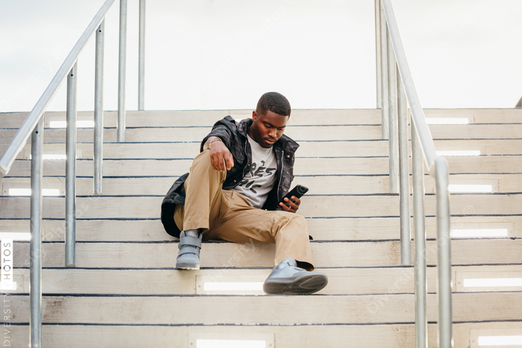 Low angle view of man sitting on stairs