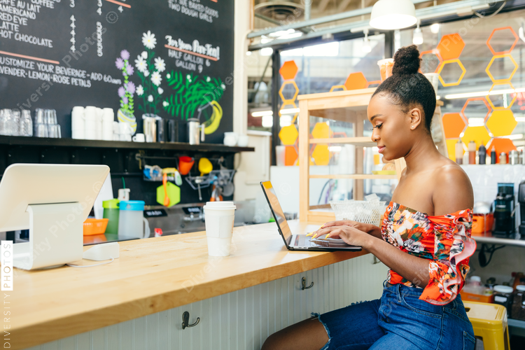 Woman working on laptop at coffee shop