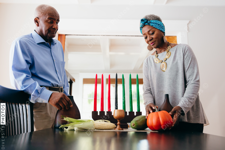 Grandparents arranging Kwanzaa set