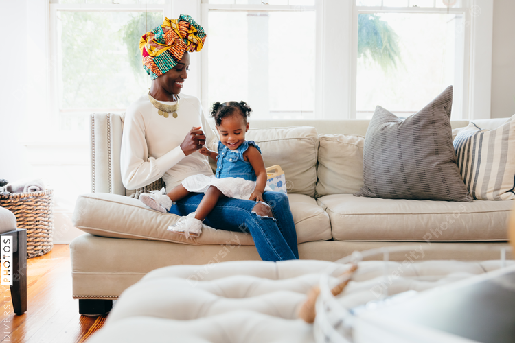 Girl sitting on lap of mother