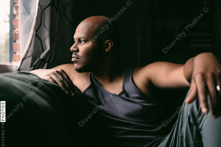 Man looking out window at home
