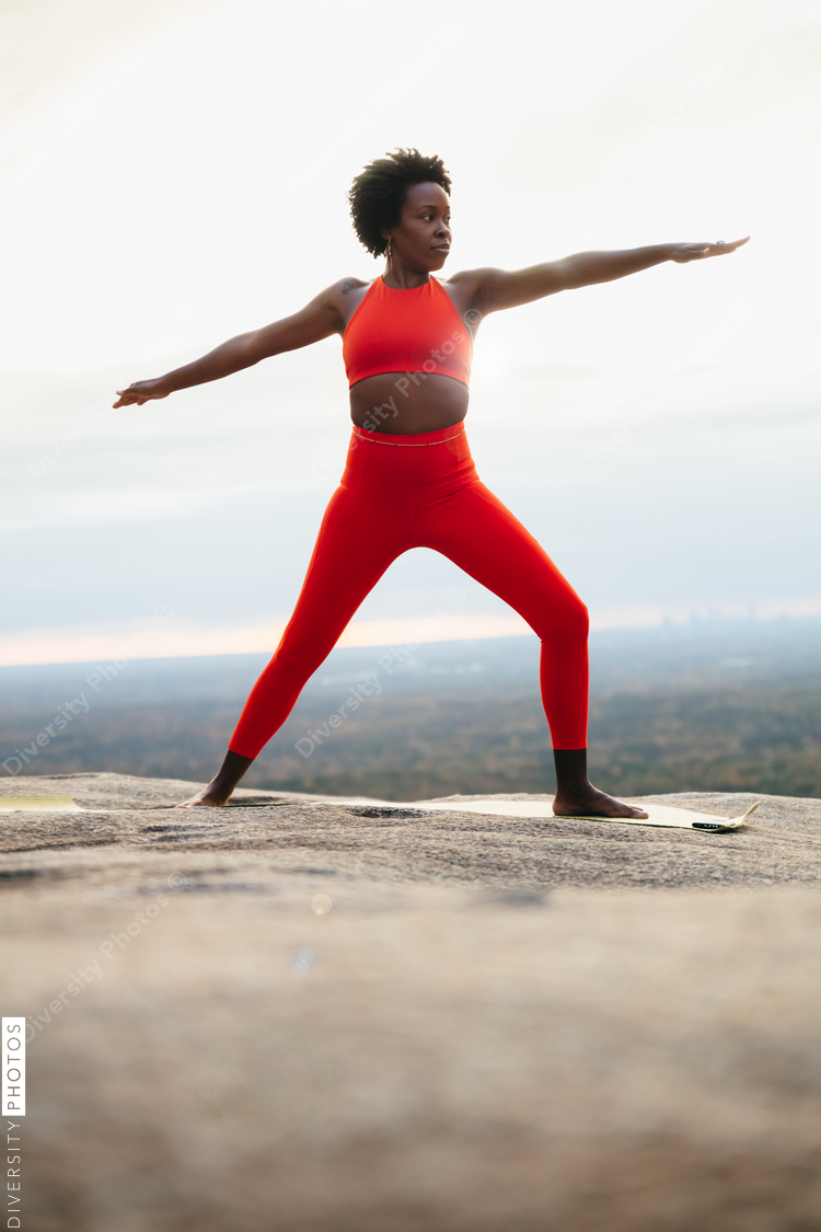 Black woman doing yoga at park