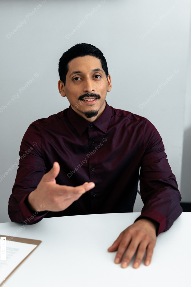 Hispanic translator talking to client