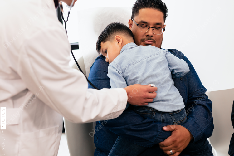 Doctor examining young hispanic toddler with stethescope