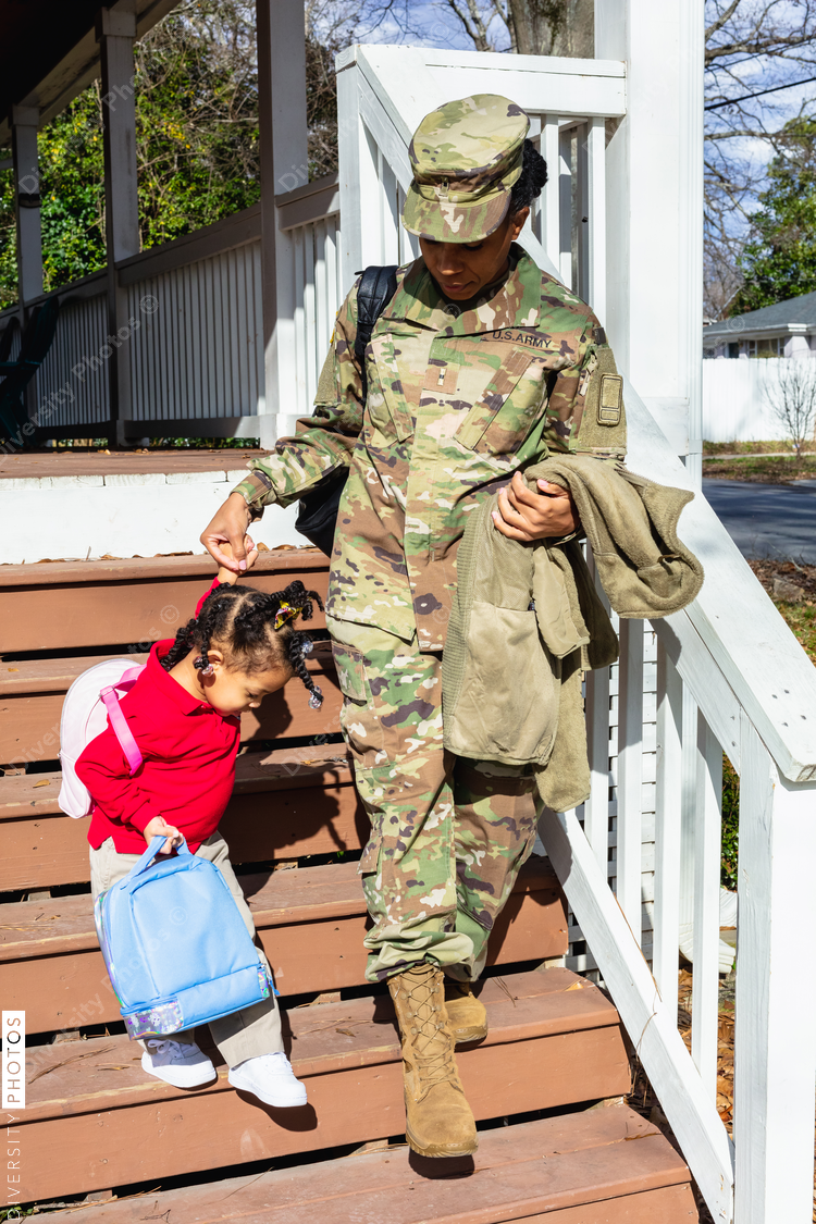 Military mother walking daughter to school