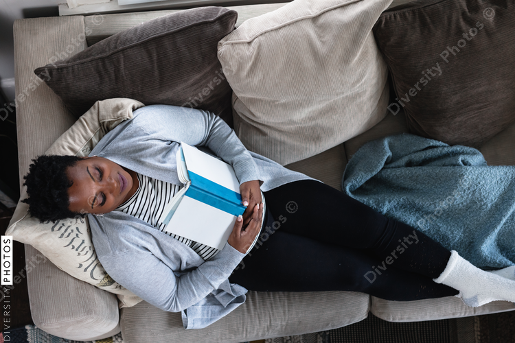 Black woman relaxed on couch at home, comfortable,sleep