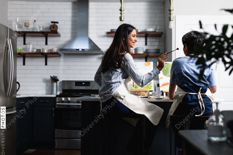 Indian mother and son playing while painting, home art activities