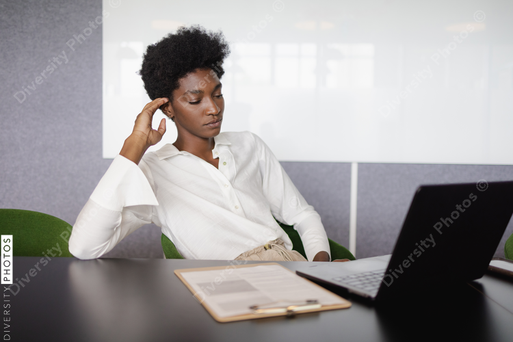 Focused businesswoman in team meeting, African American