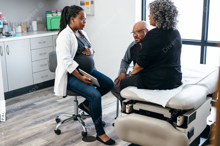 African American female doctor consults with senior medical patients