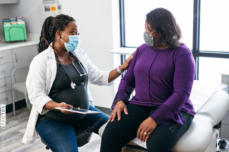 Black doctor consulting with senior patient about lab results, connection