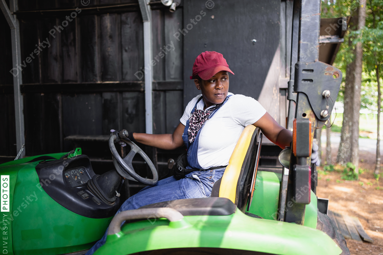 African American Female farmer on tractor