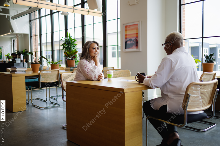 Black and Asian colleagues having coffee and tea, during break