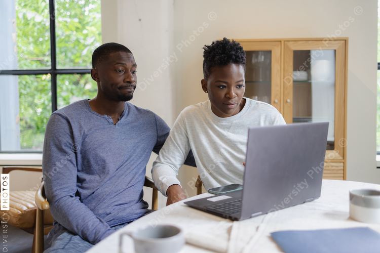 Black Couple using laptop at home