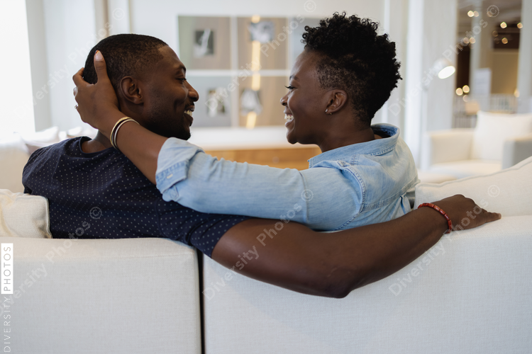 Black Couple embracing on sofa