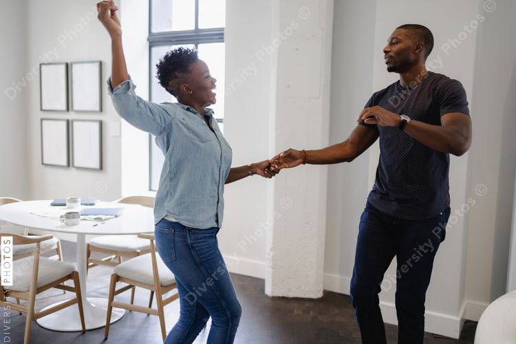 Black Couple dancing in living room