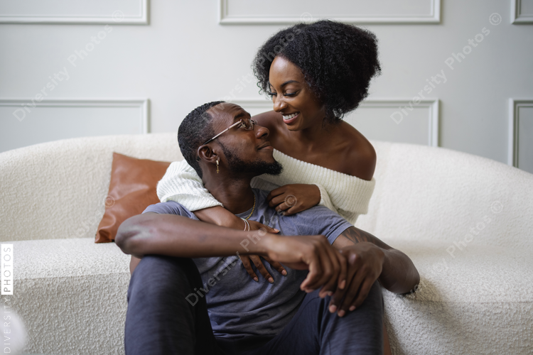 Smiling couple embracing in living room