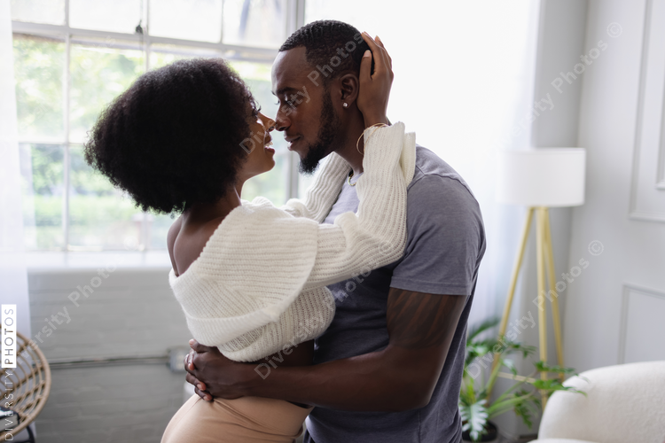 Young couple hugging at home