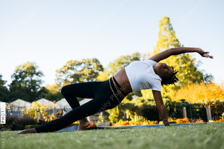 African American woman does yoga in the park