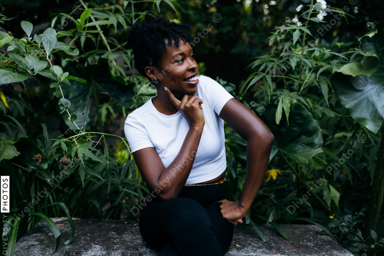 Portrait of smiling Black woman with plants in background