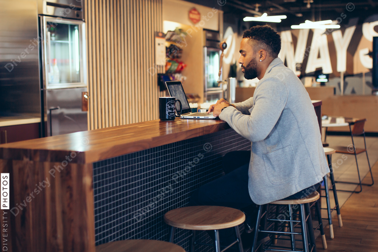Side view of businessman using a laptop while sitting in office