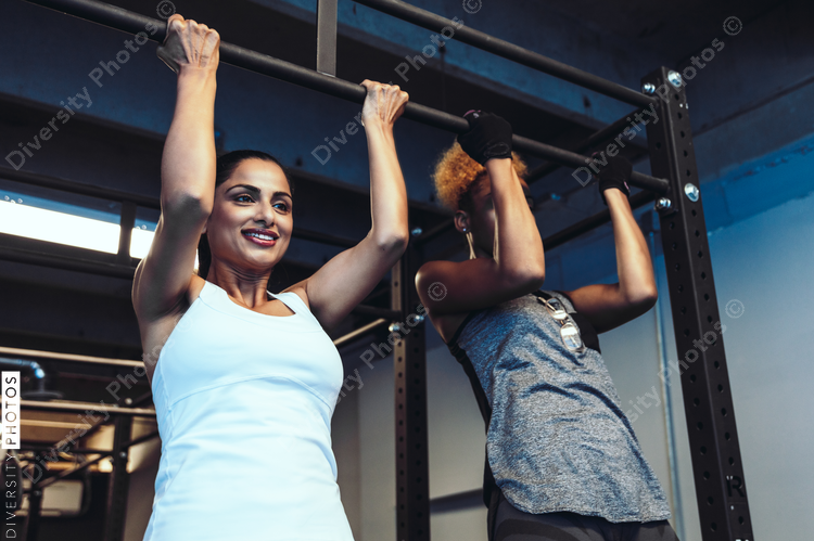 Young friends working out in gym