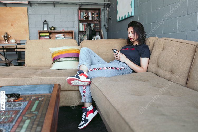 Young woman using smartphone in coffee shop