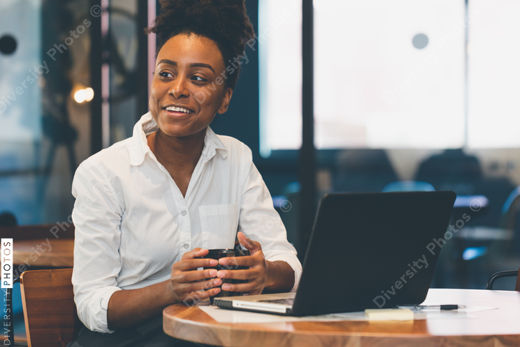 Smiling businesswoman having coffee in office