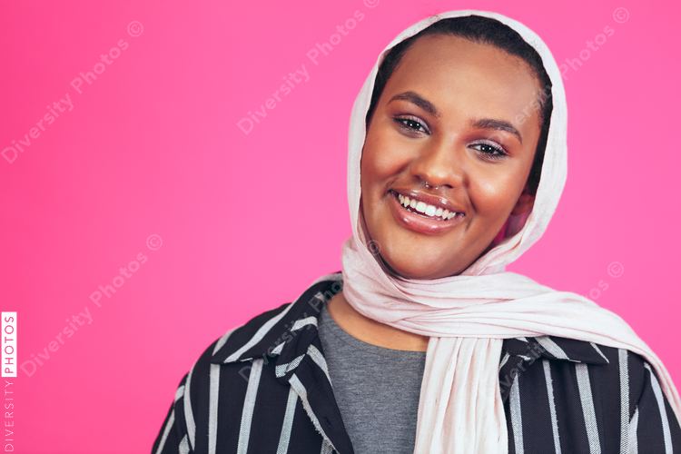 Portrait of smiling young woman with nose ring and headscarf