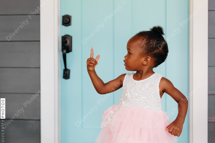 Girl in tutu pointing her finger while standing outdoors