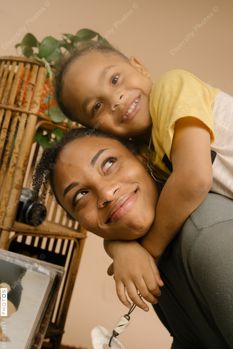 Joy of motherhood Black mother and son hugging at home - Diversity Photos