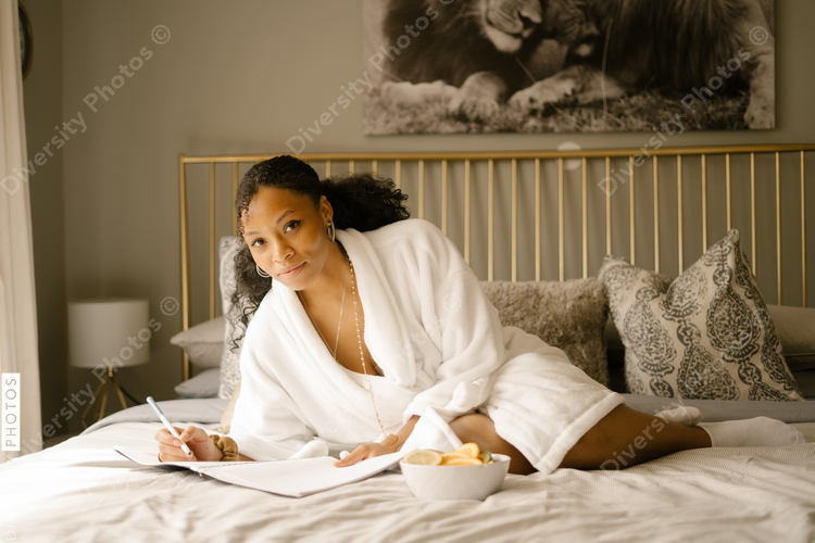 Black woman self care Sunday at home in bed