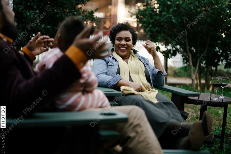 Black friends safely gathered and enjoying a backyard kickback party